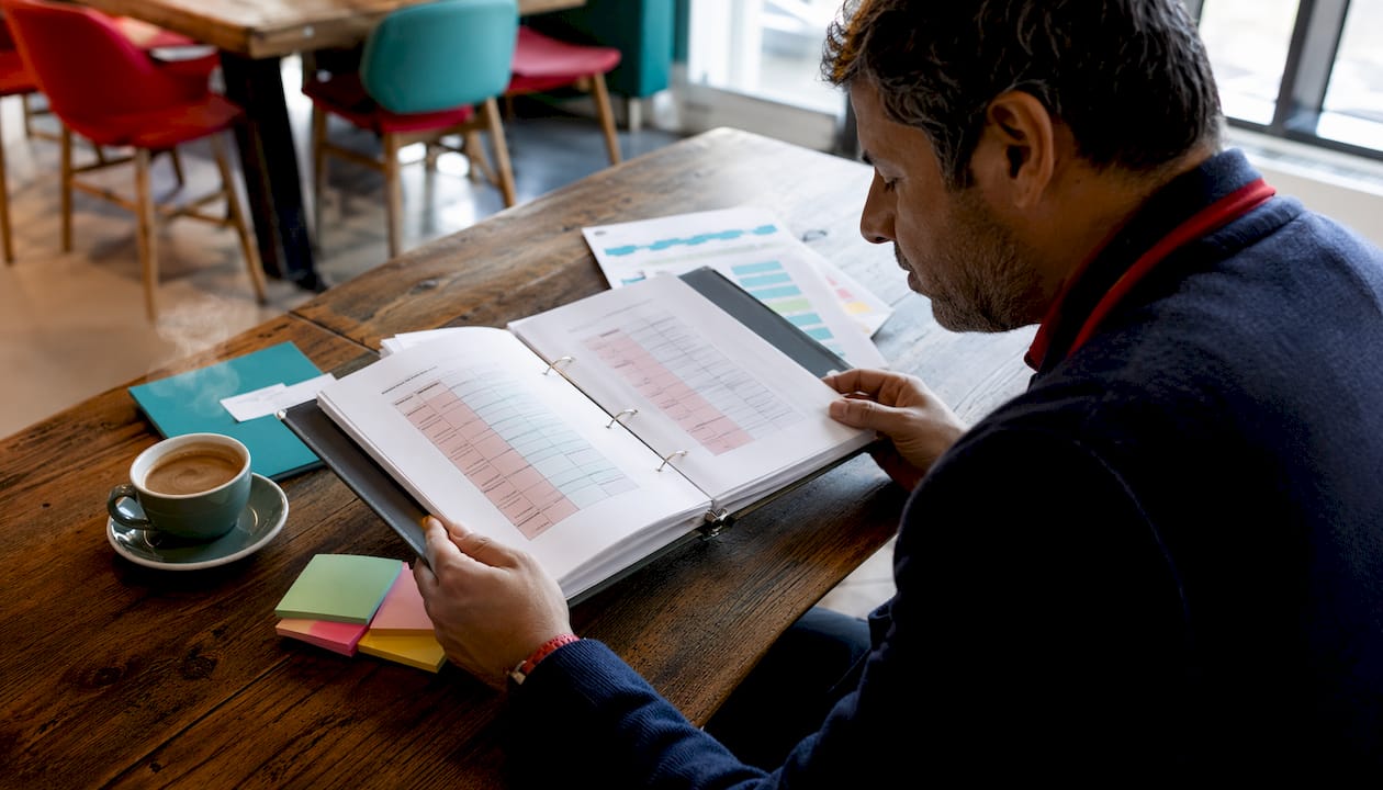 Man managing terminology glossary binder