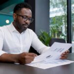 Manager reviewing VIP support reports in office