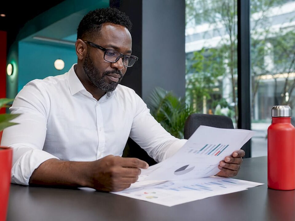Manager reviewing VIP support reports in office