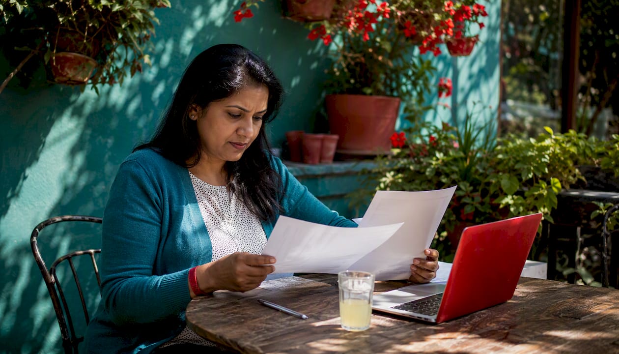 Hands reviewing SLA contract pages at conference table