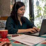 Woman providing player support at home office desk
