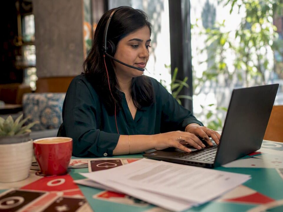 Woman providing player support at home office desk