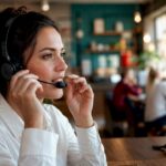 Support agent hands holding headset microphone