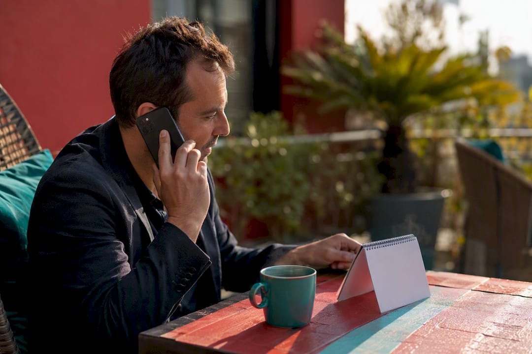 Hands holding phone making business call